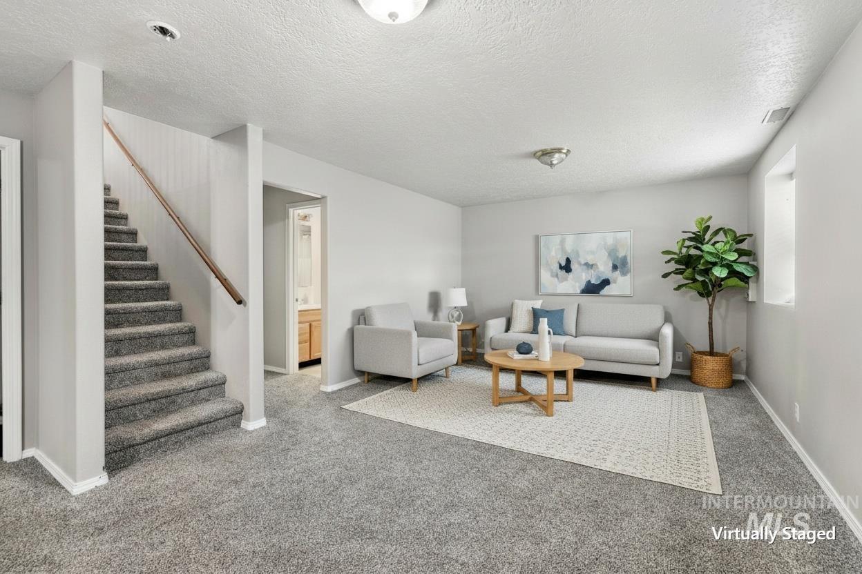 Carpeted staircase with wood railing