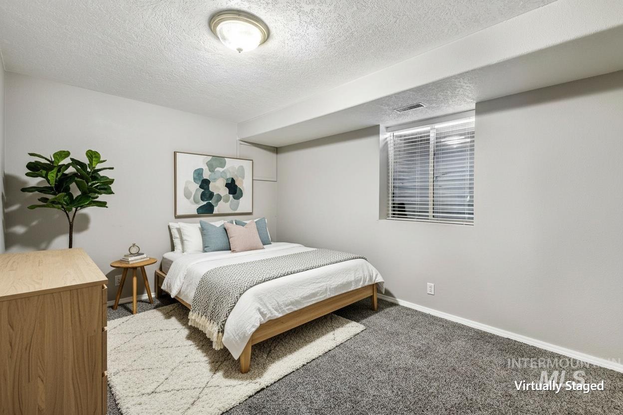 Carpeted room with a recessed window featuring blinds, light gray wall paint, and a semi-flush ceiling light fixture