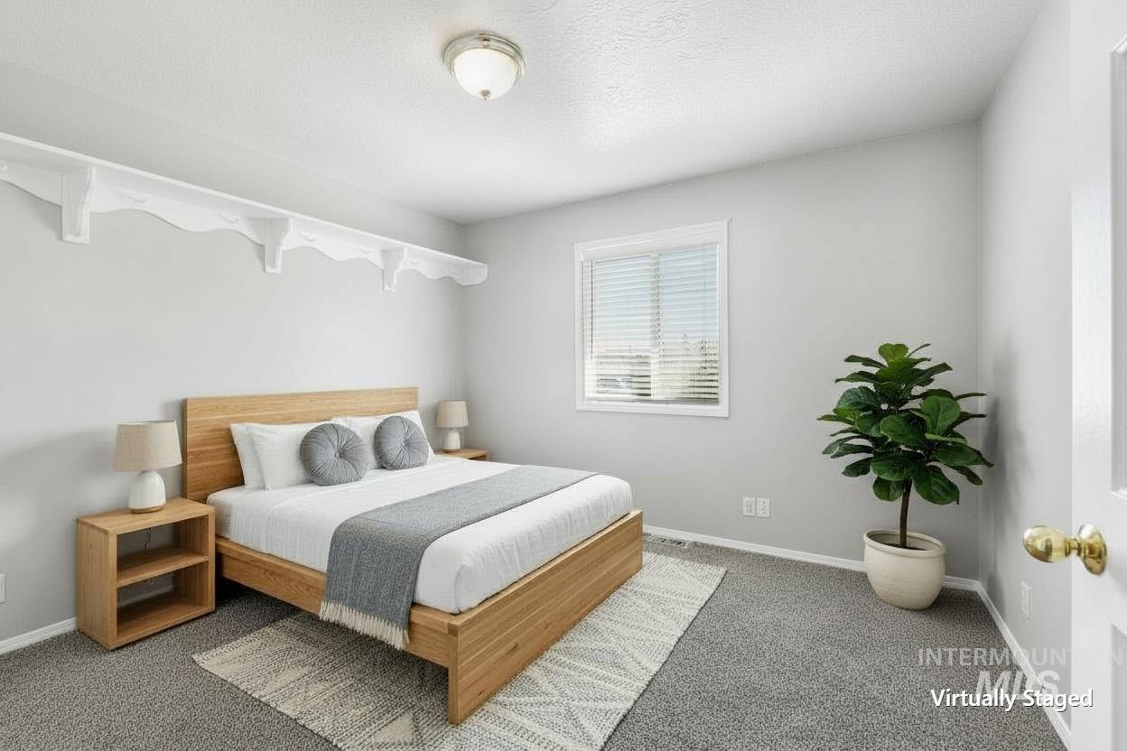 Carpeted bedroom featuring neutral wall tones, a single window with horizontal blinds, white trim, and a flush mount ceiling light fixture