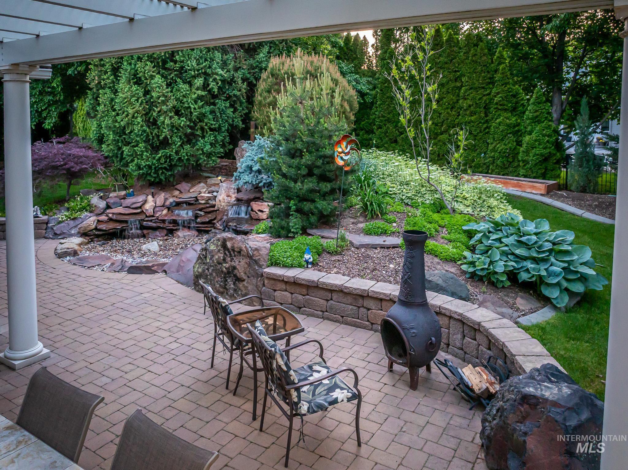 View of patio with a pergola and a fire pit