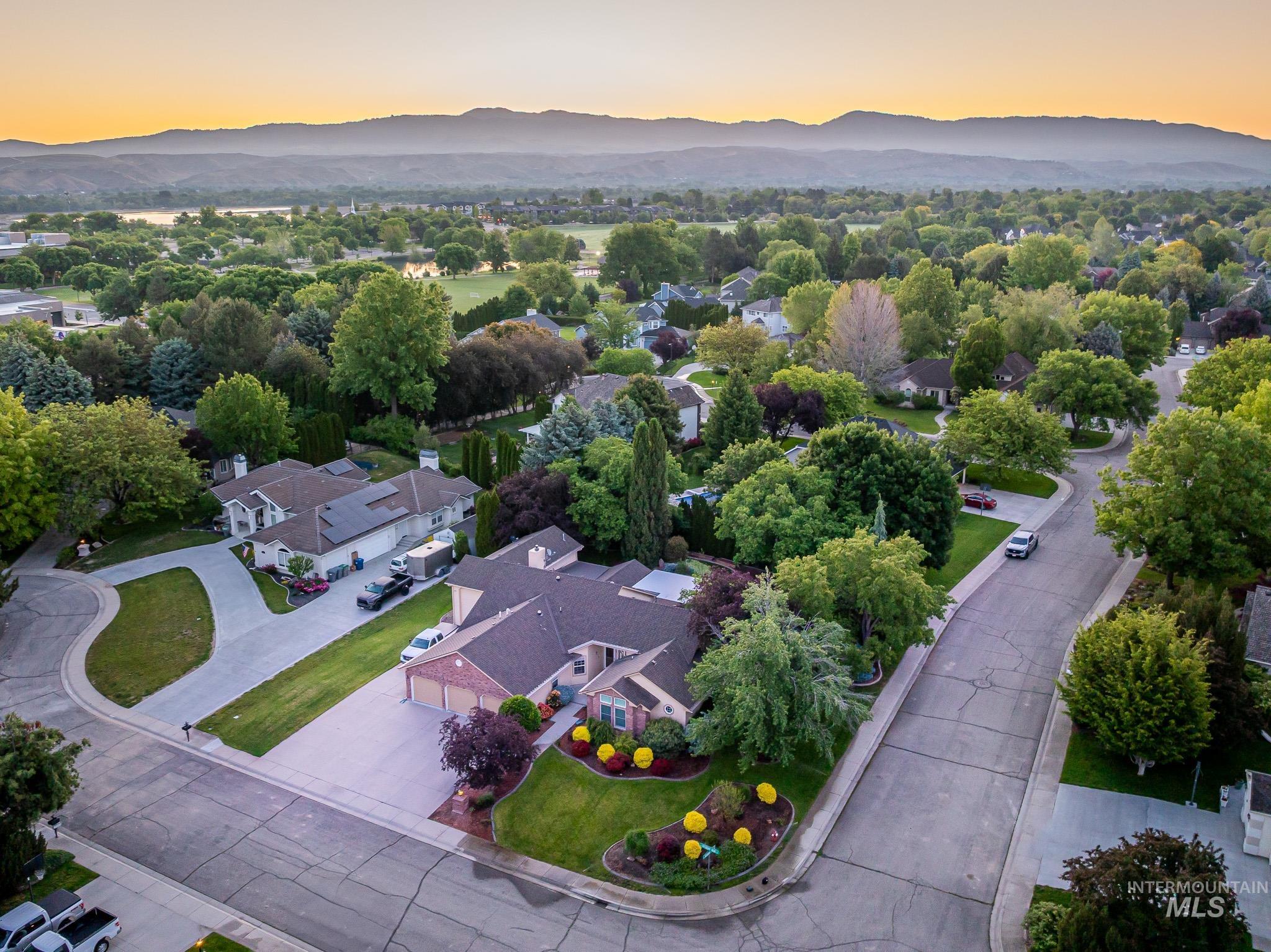 Aerial perspective of suburban area featuring a mountain backdrop