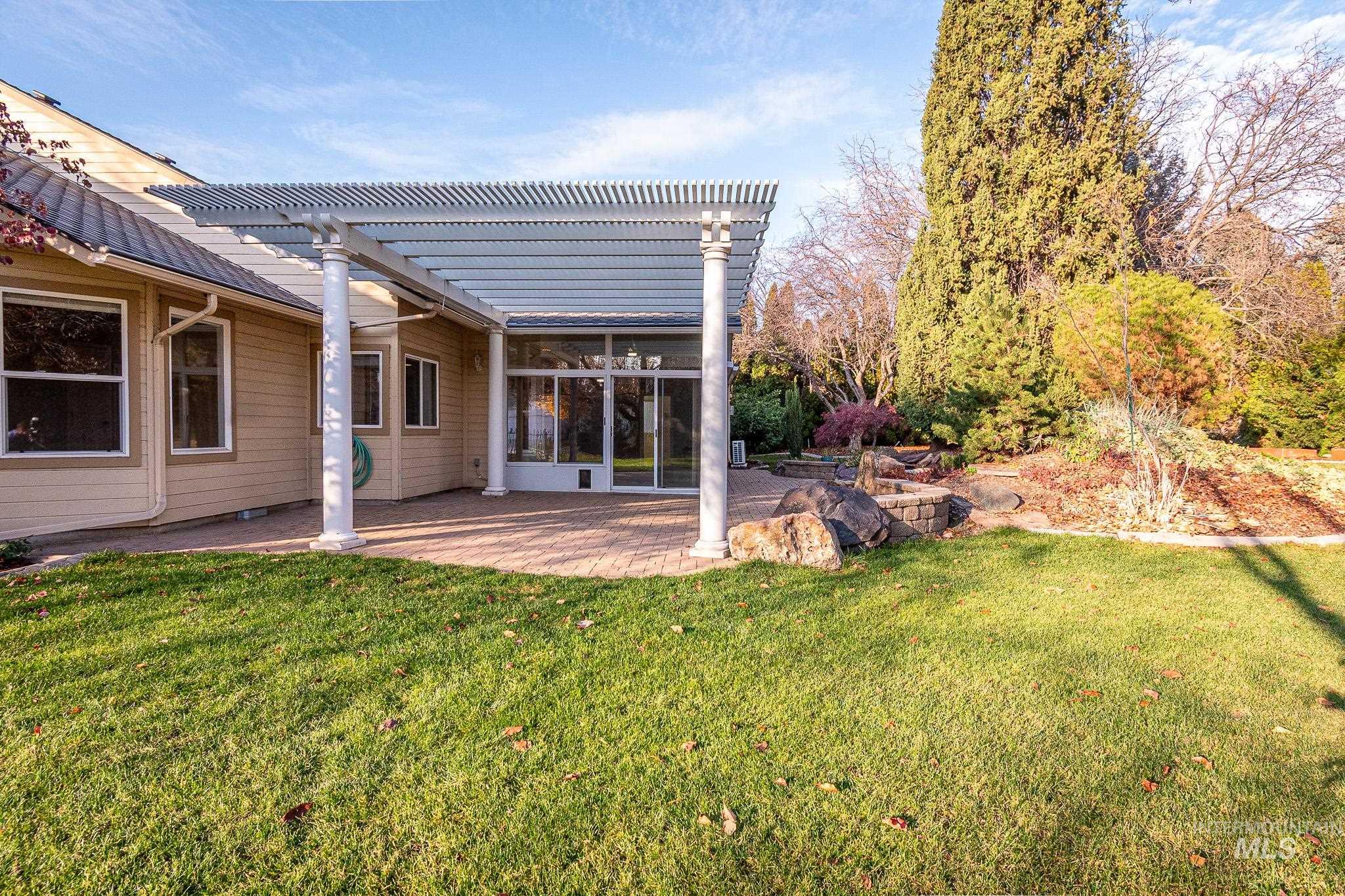 View of green lawn featuring a pergola and a patio