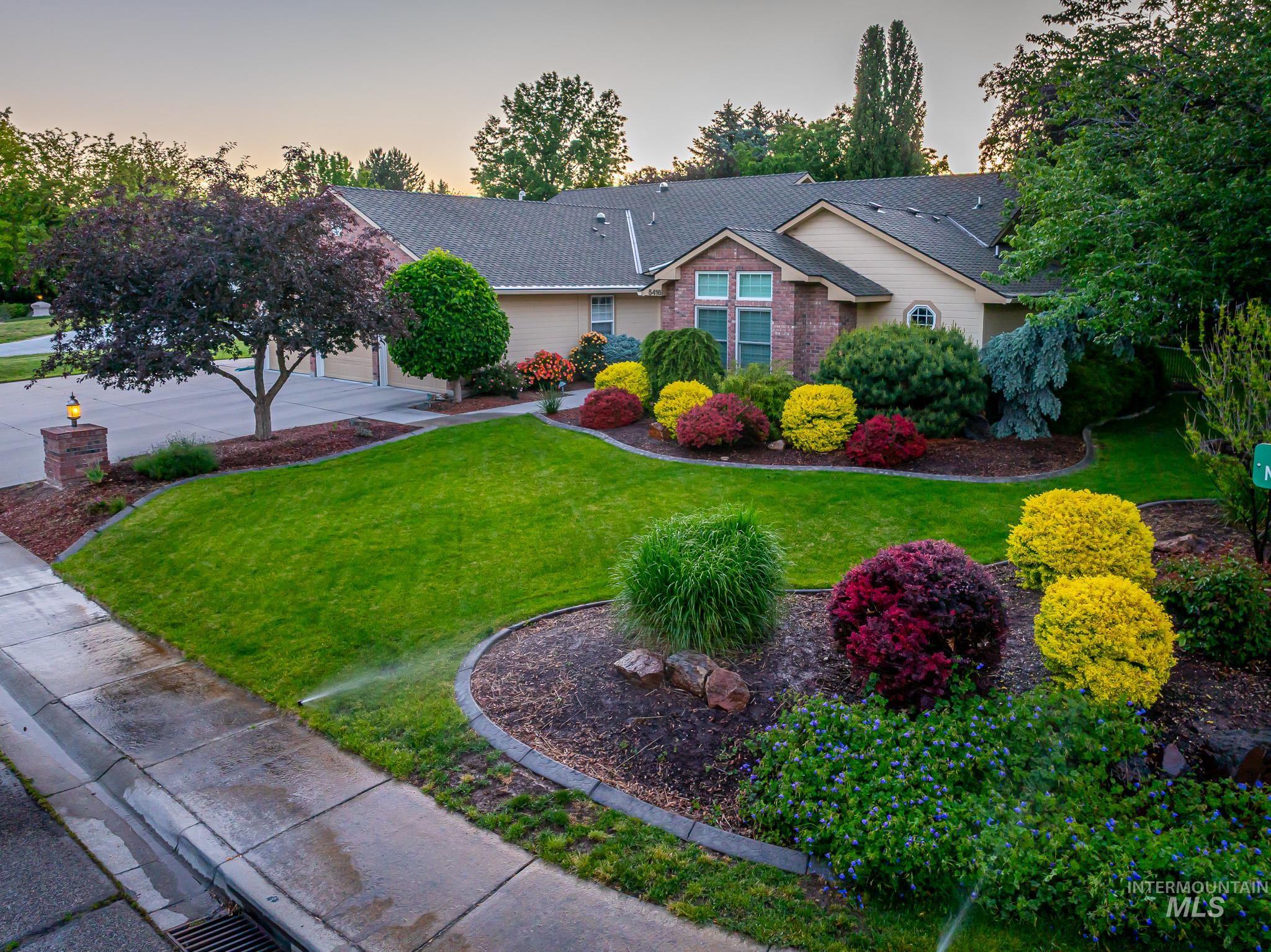 Ranch-style home featuring a yard, brick siding, and roof with shingles