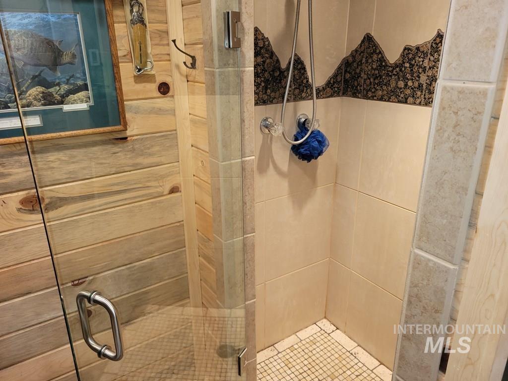 Full bathroom featuring a shower stall
