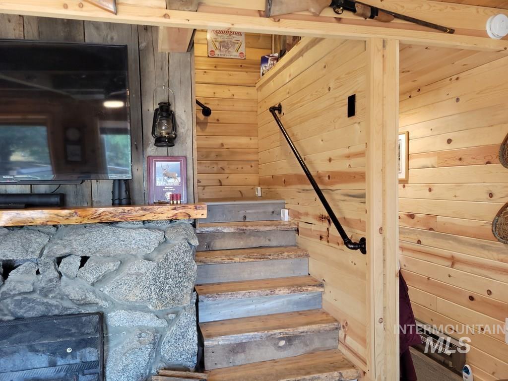 Stairway featuring wooden walls