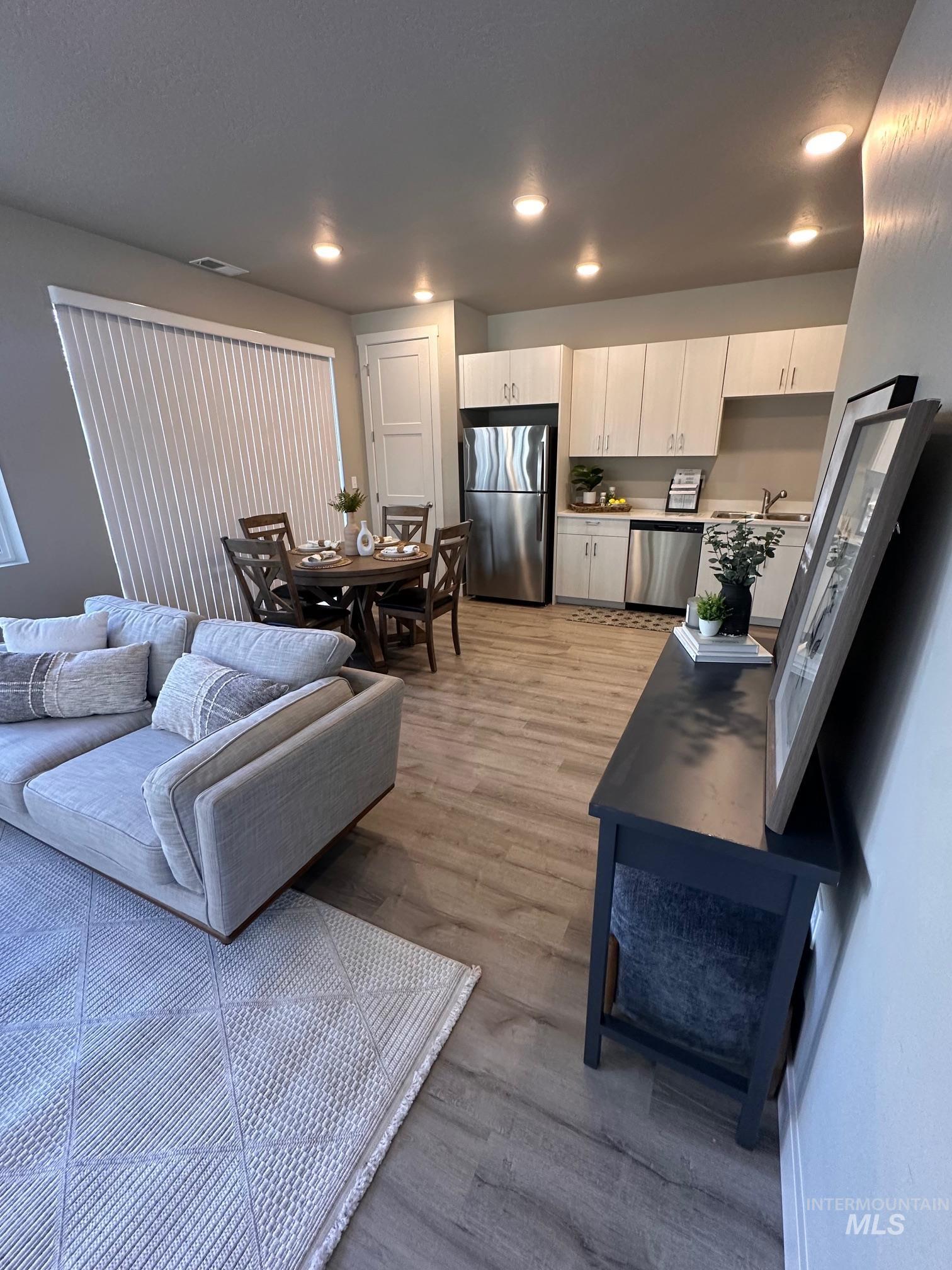 Living room featuring light wood-style floors and recessed lighting