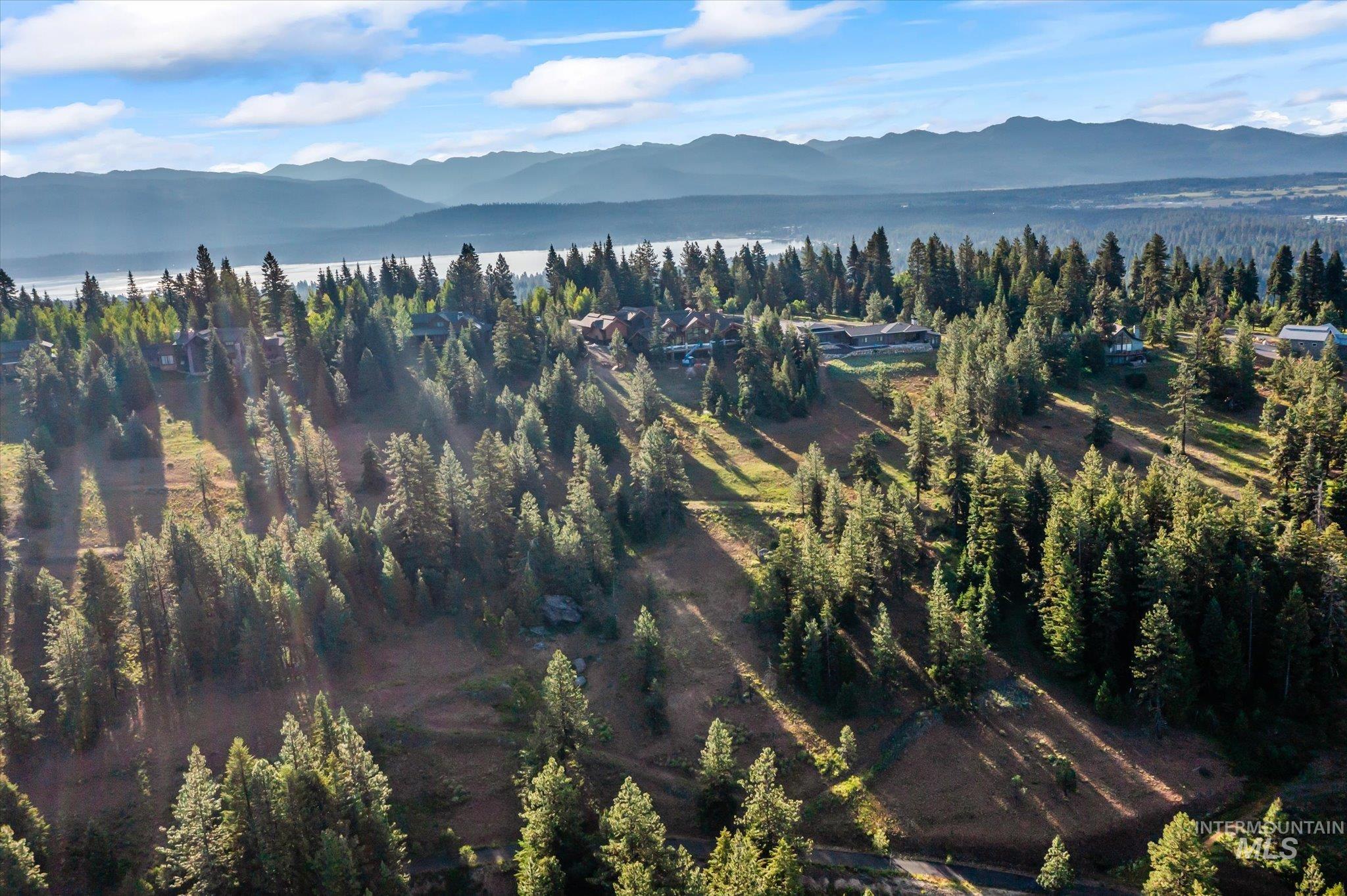 Aerial overview of property's location with a water and mountain view