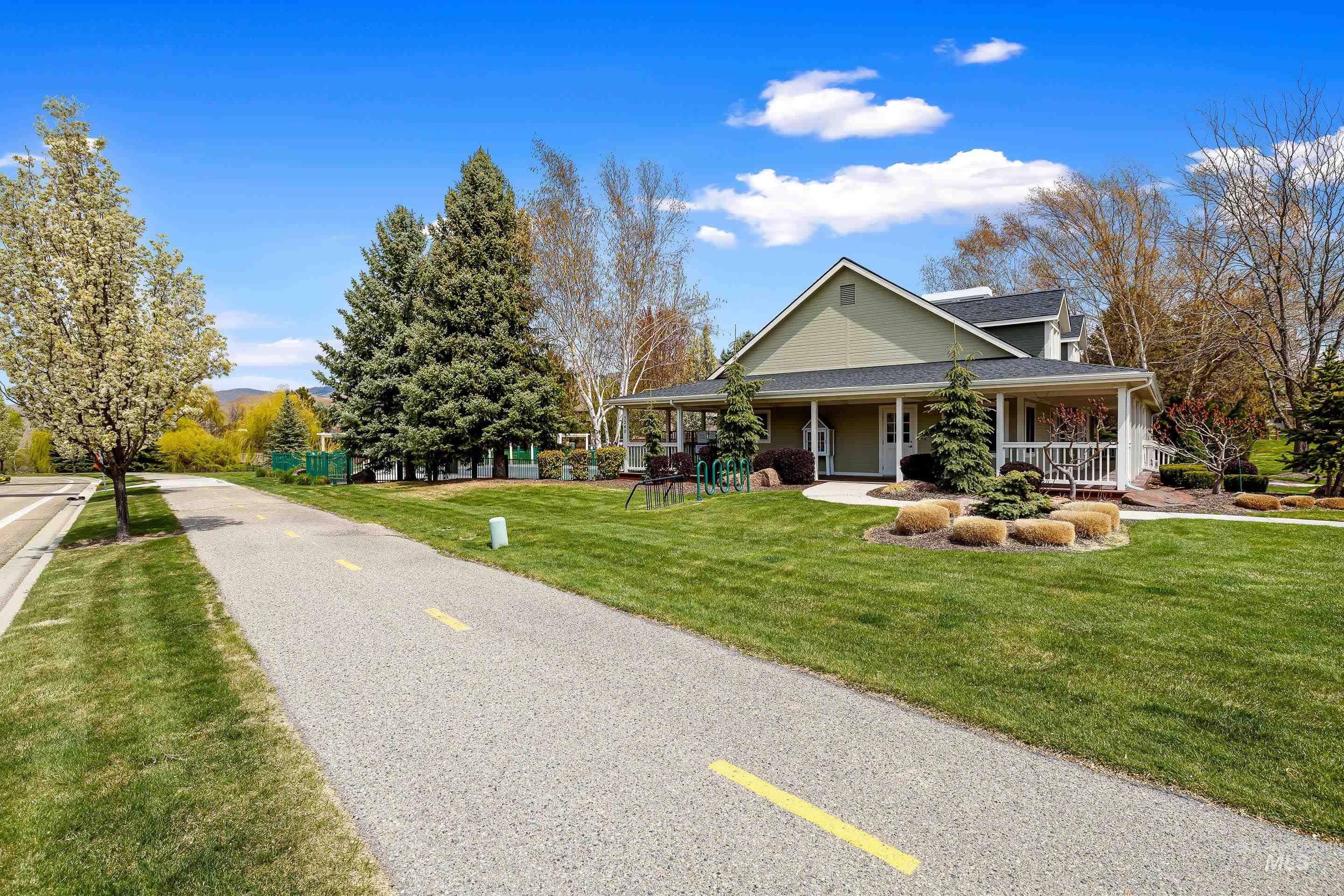 Country-style home with a porch and a front lawn