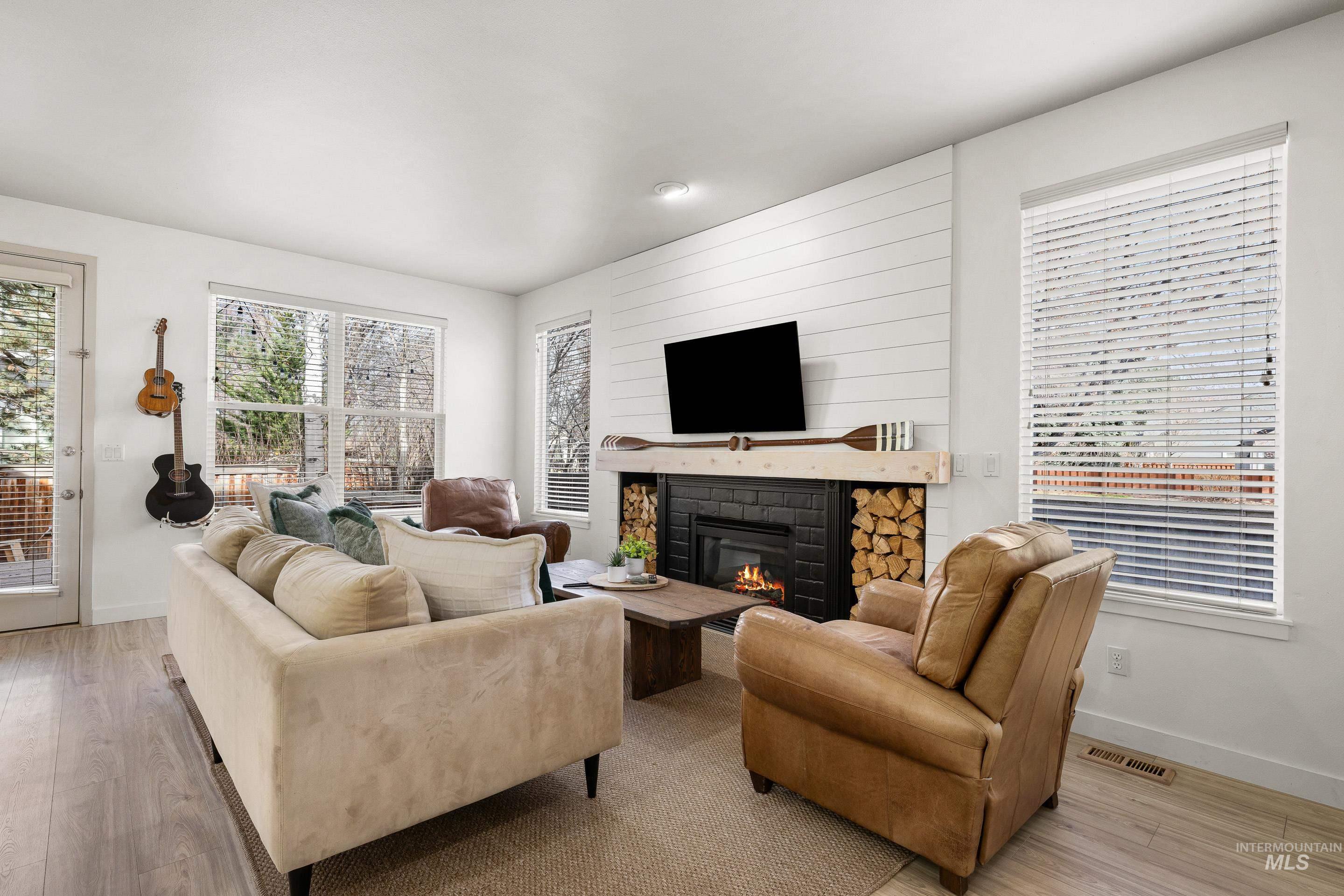 Living area with wood finished floors and a fireplace