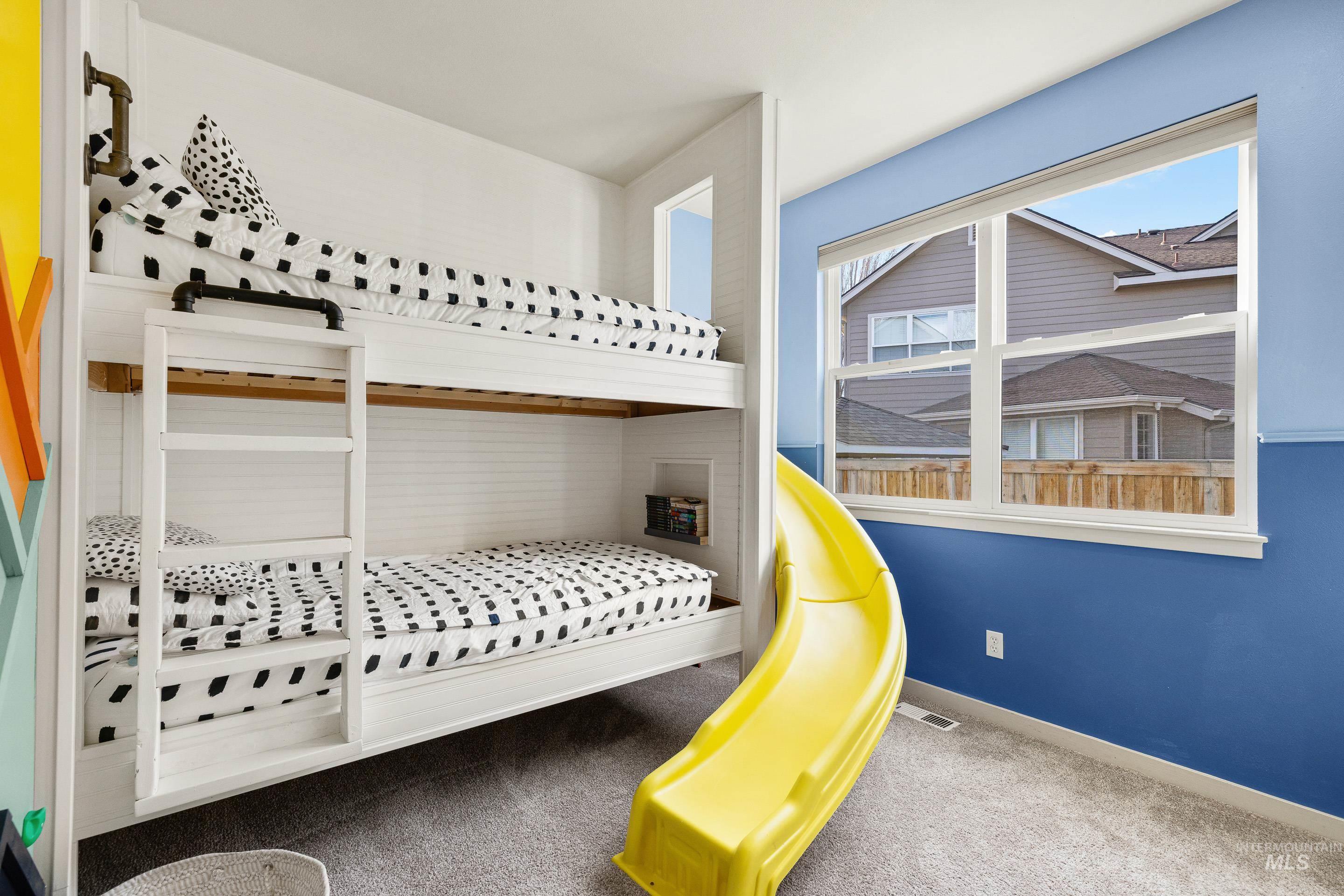 Bedroom with dark carpet and baseboards