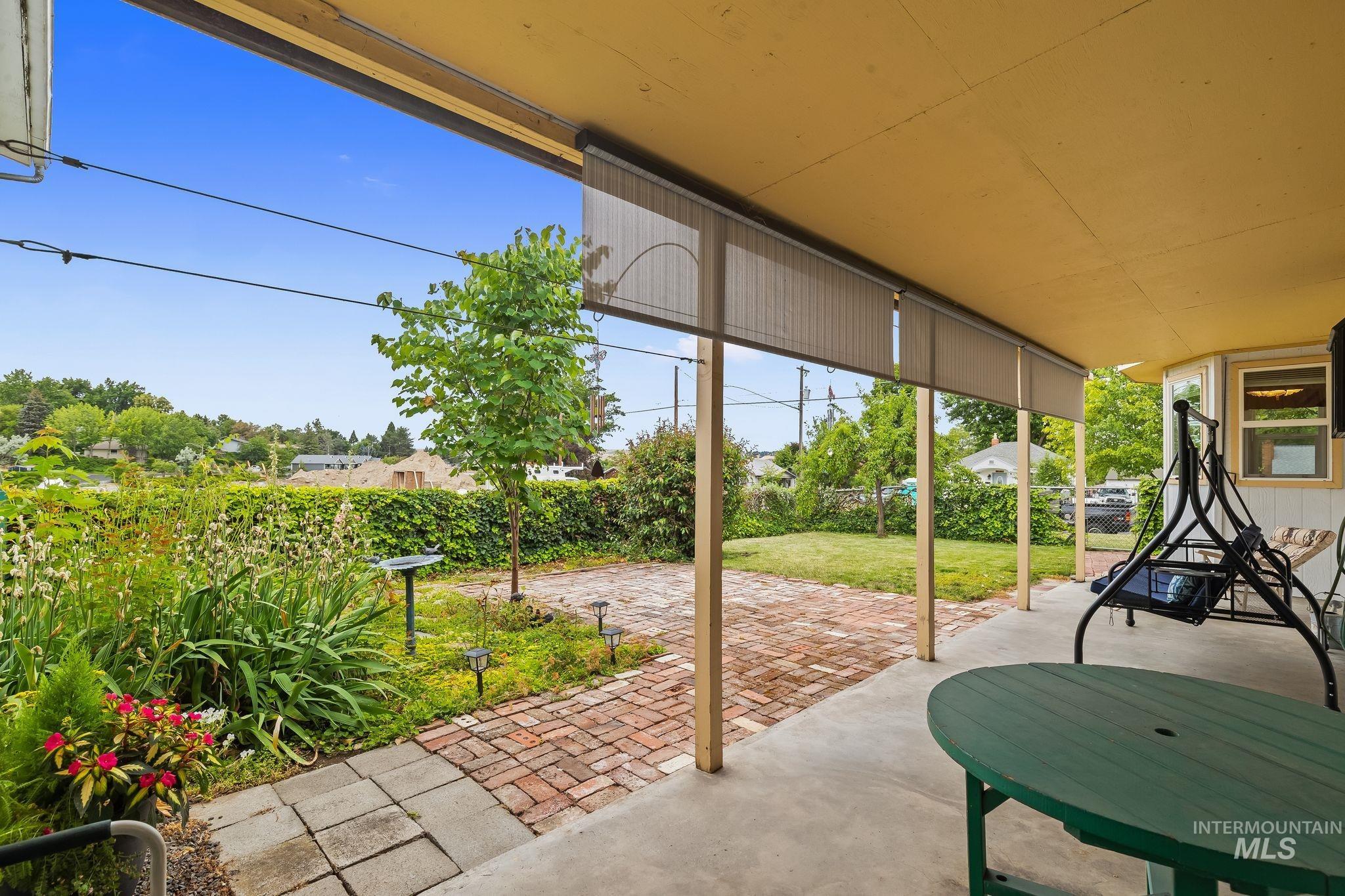 Covered patio space featuring a concrete floor and privacy screens