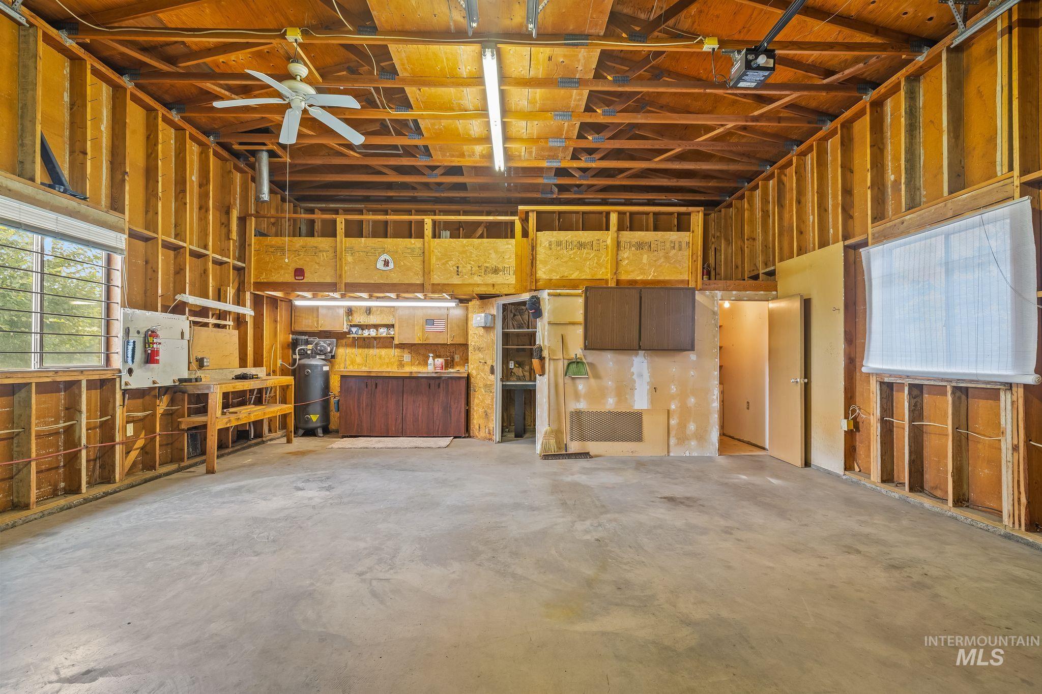 Spacious unfinished garage with exposed wood framing and high ceilings