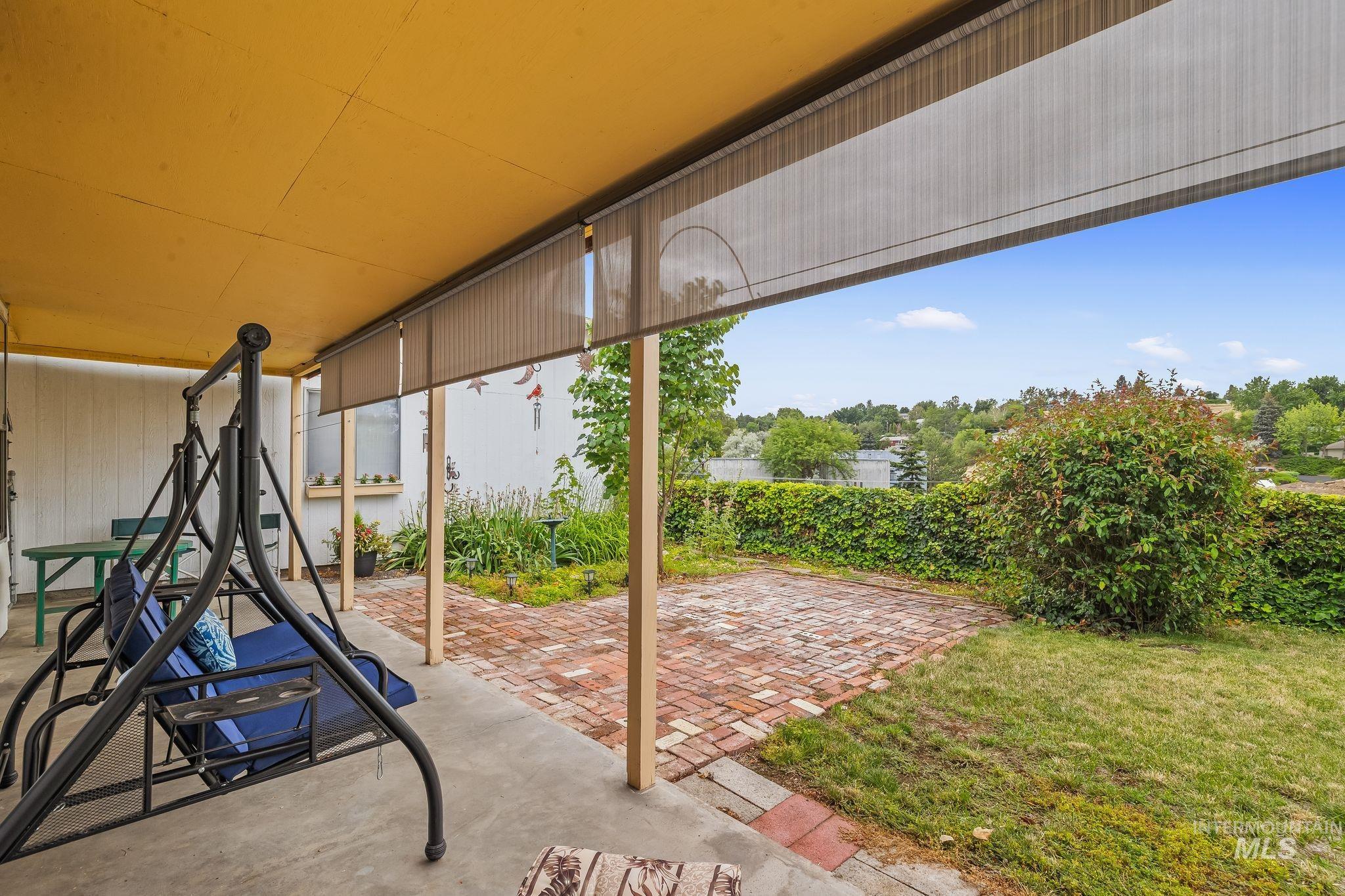 Covered concrete patio featuring an exposed aggregate finish and a bright yellow ceiling