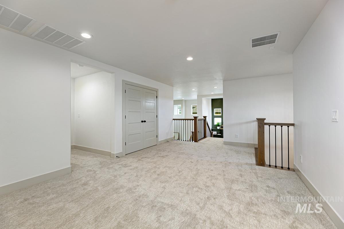 Unfurnished room featuring recessed lighting and light carpet