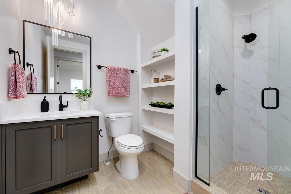 Bathroom with vanity and a shower stall
