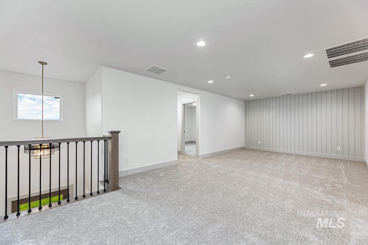 Spare room with light colored carpet and recessed lighting