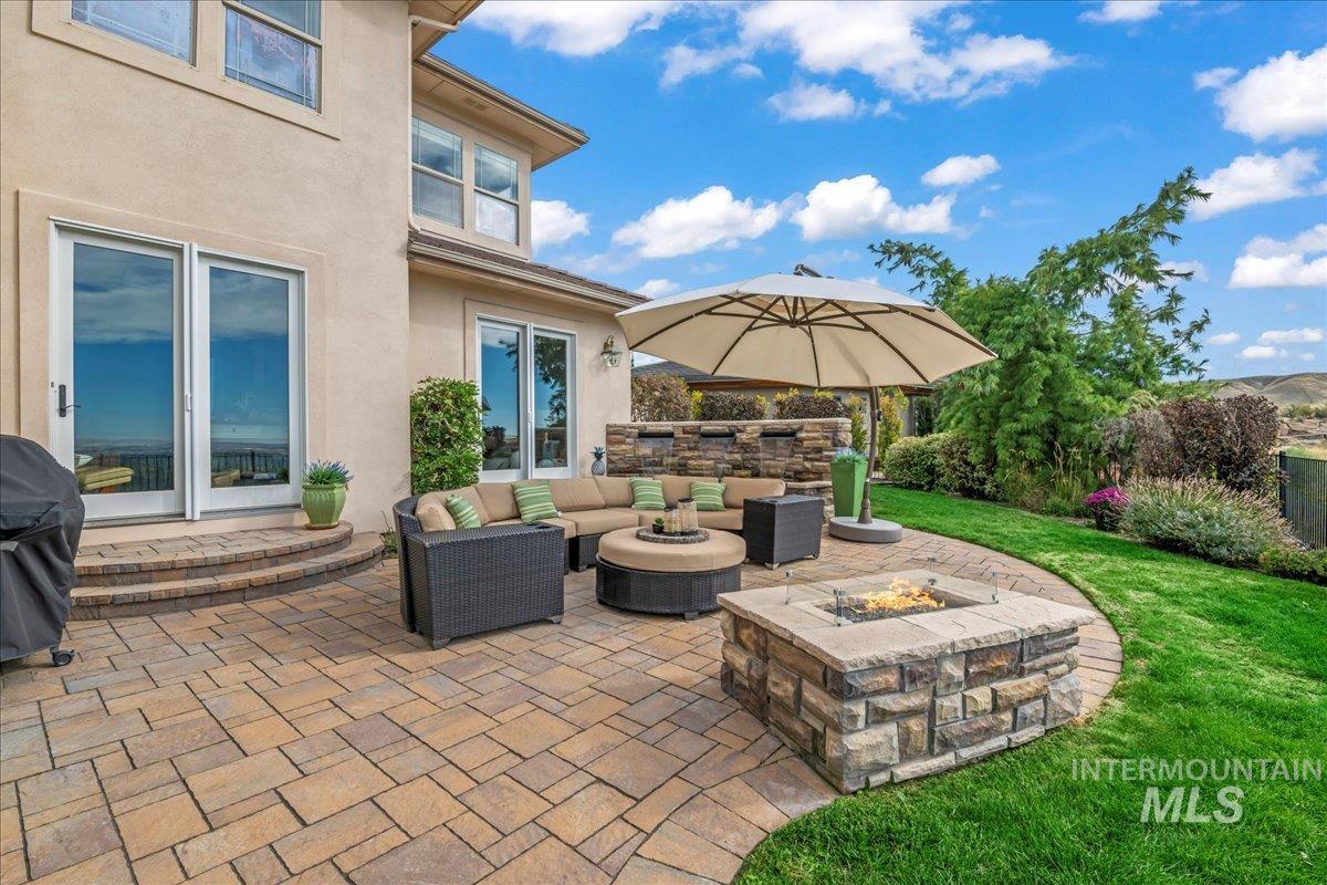 View of patio / terrace featuring a grill and an outdoor living space with a fire pit