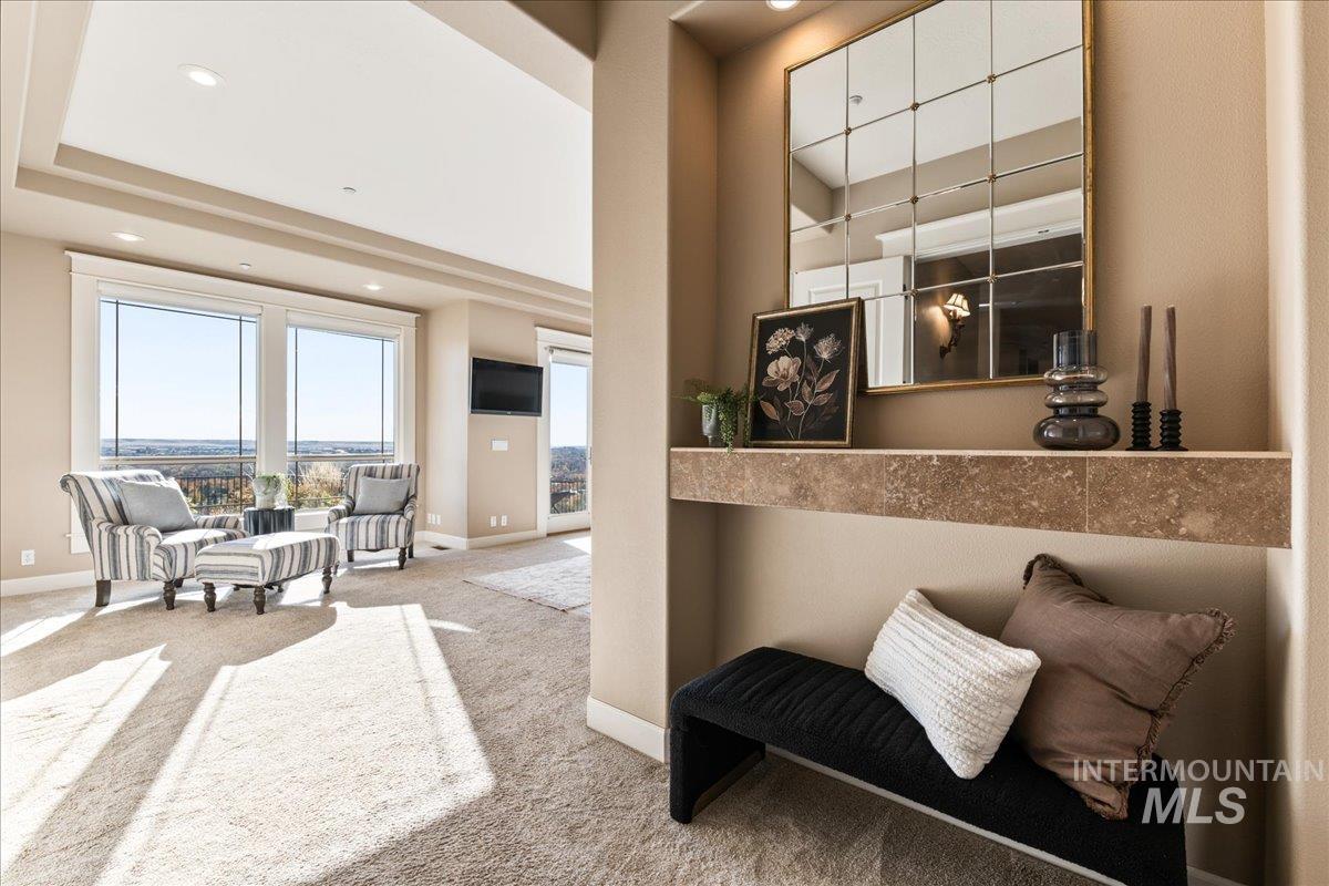 Living area with carpet flooring and recessed lighting