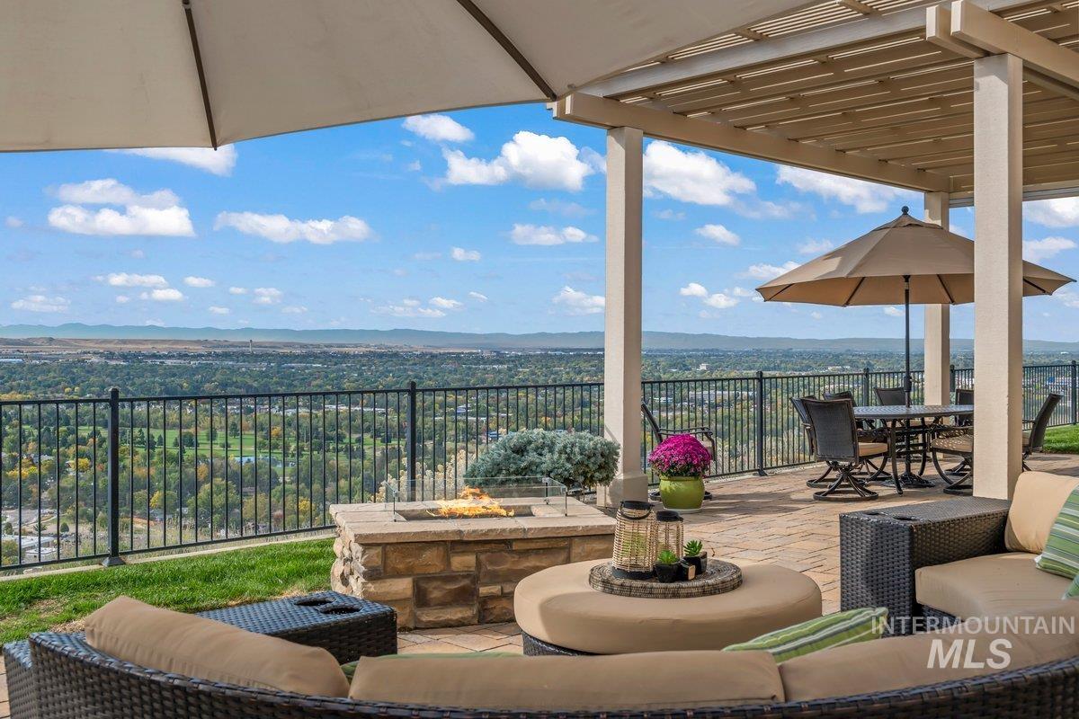 View of patio / terrace with a mountain view, an outdoor living space with a fire pit, outdoor dining area, and a pergola