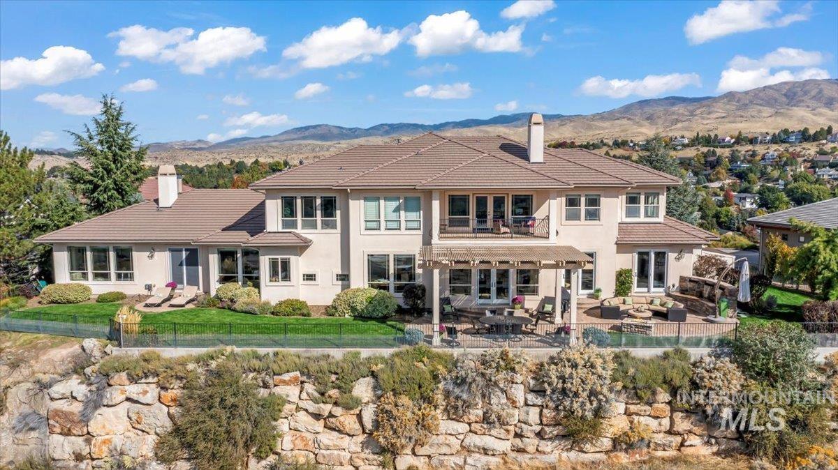 Back of property with a patio area, a fenced backyard, access to the foothills trails, and 360 degree views