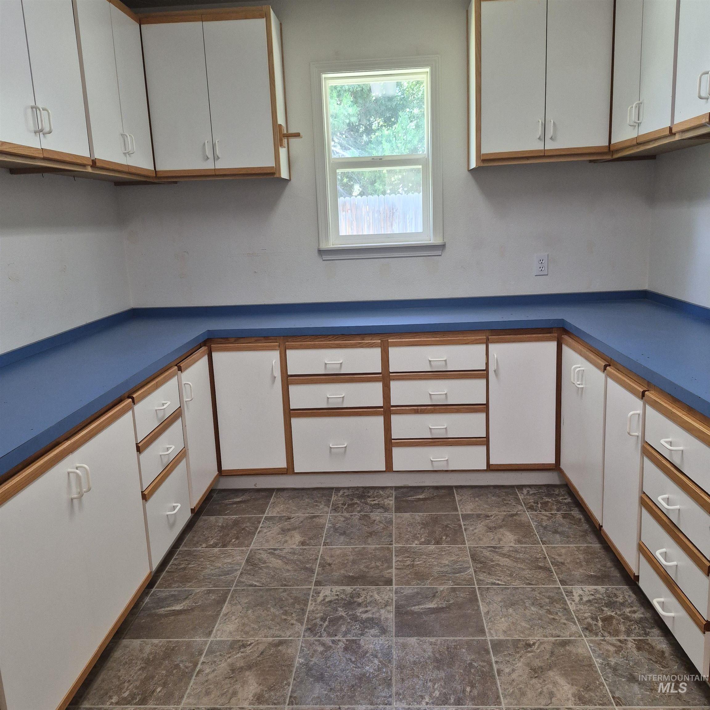 Extensive white cabinetry with wood-finish trim