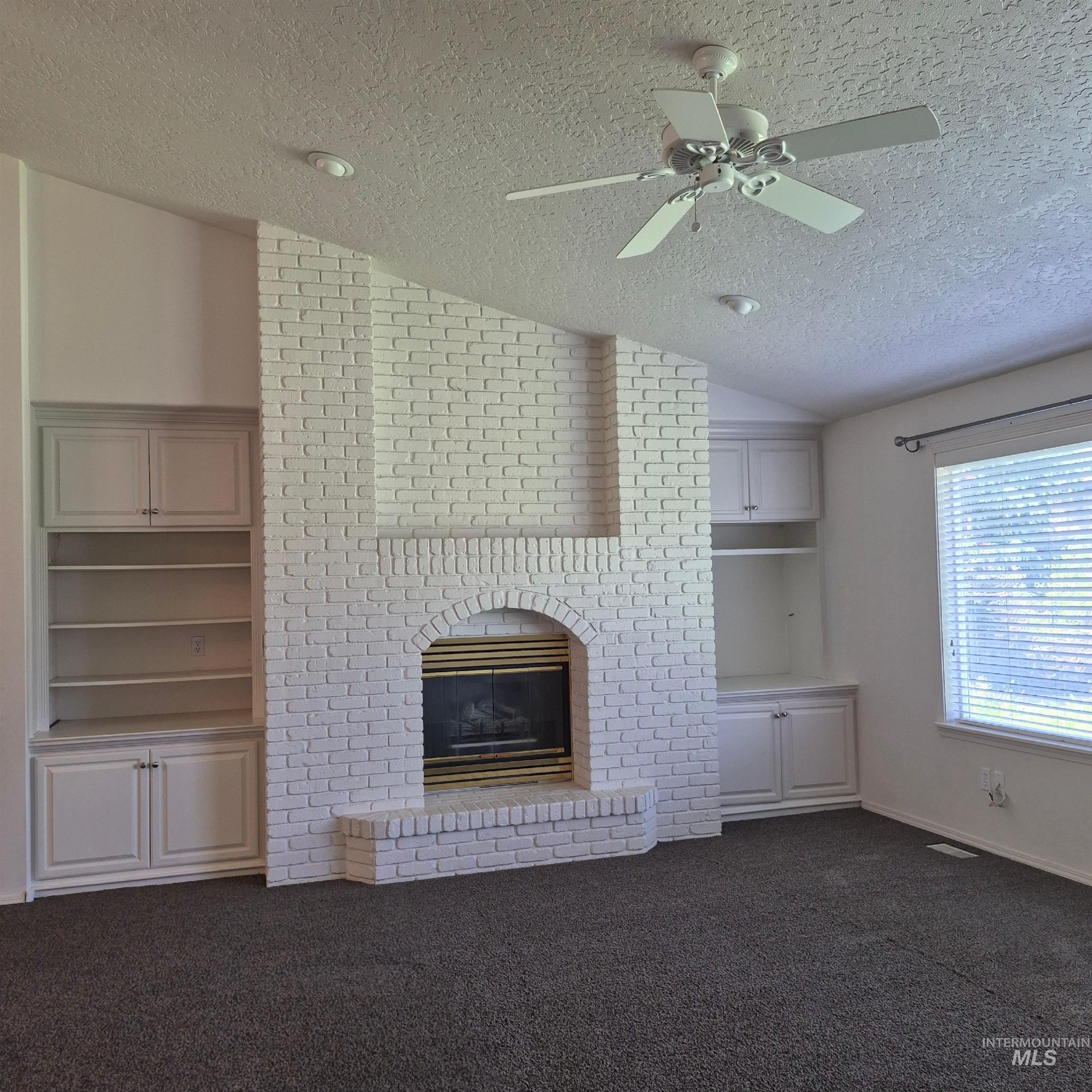 White-painted brick fireplace with an arched firebox