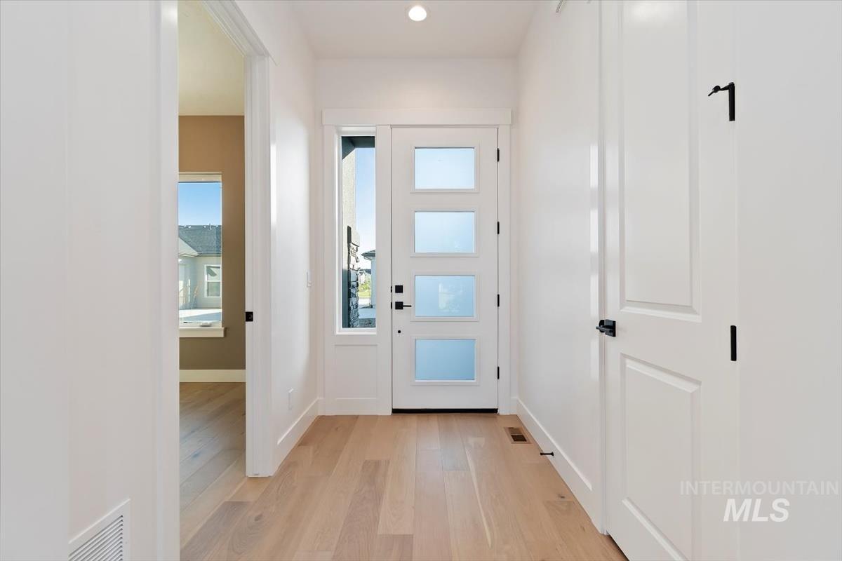 Entryway featuring wood finished floors and recessed lighting