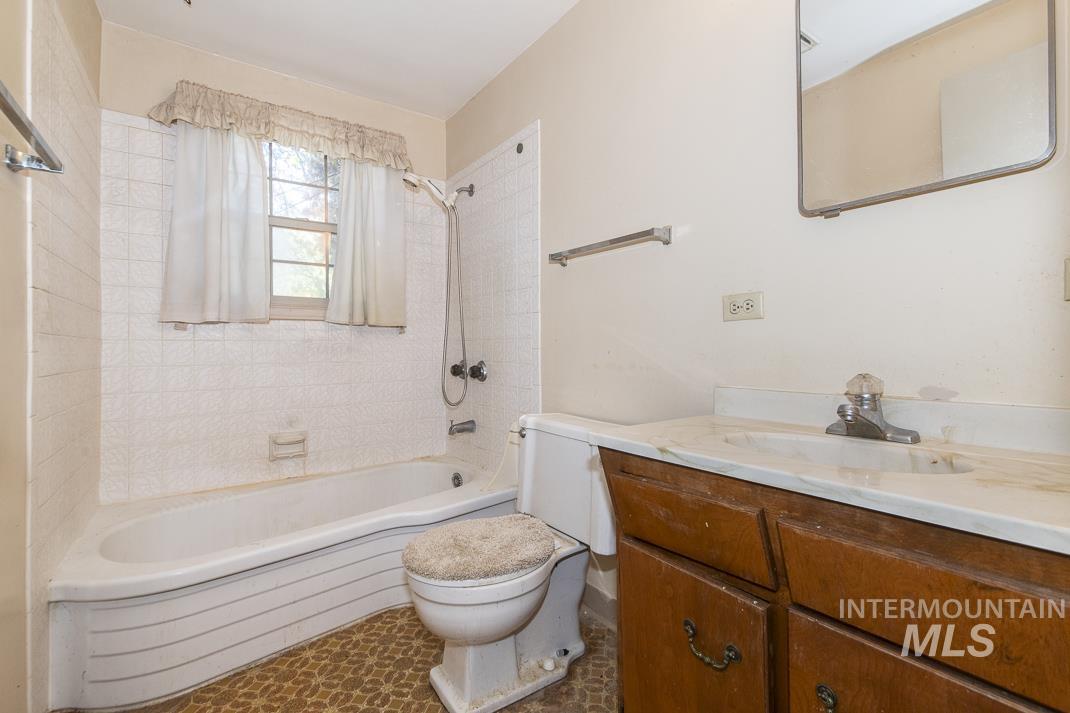 Bathroom with vanity and  shower combination