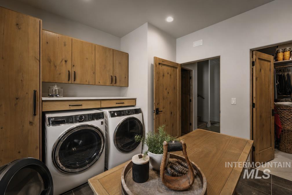 Dedicated laundry area featuring wood-finish cabinetry and white countertop space