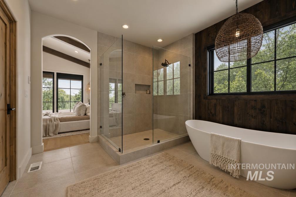Contemporary bathroom featuring a freestanding soaking tub, a frameless glass shower enclosure with a rain shower head, and an accent wall with dark wood paneling