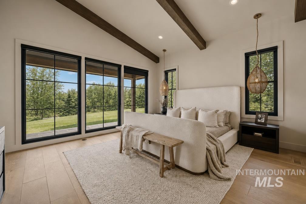 Bedroom featuring expansive black-framed windows, vaulted ceiling with exposed wood beams, wood-finish flooring, recessed lighting, and dual pendant light fixtures
