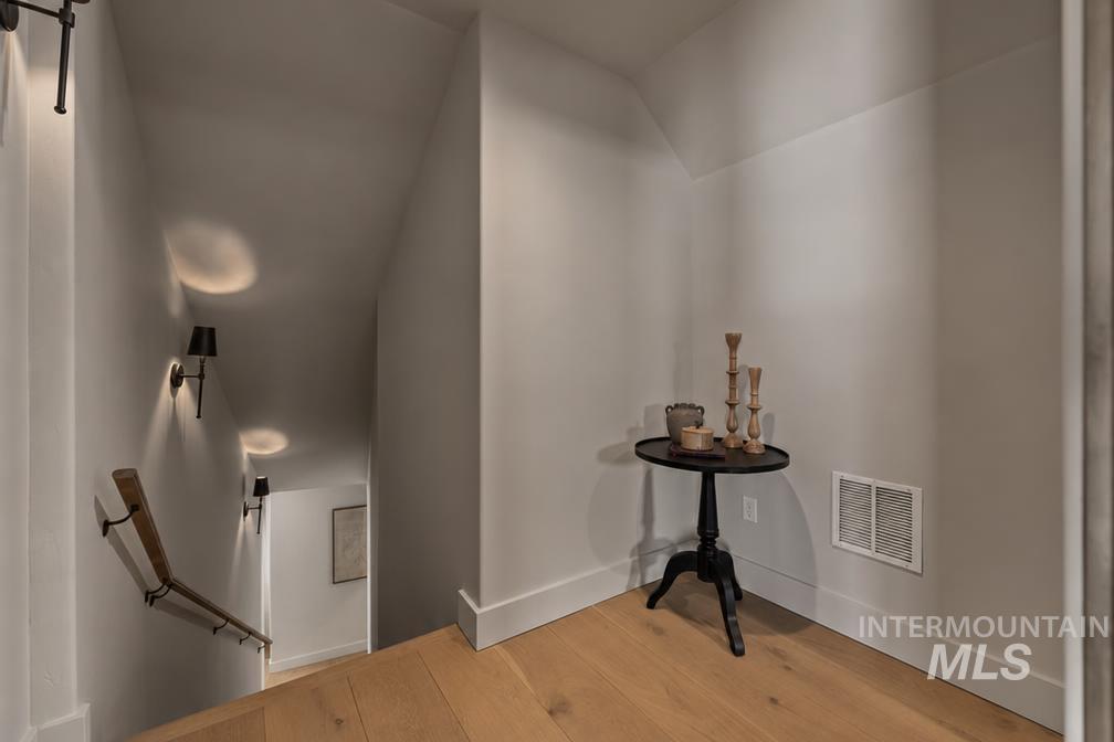 Hardwood flooring and crisp white baseboards complement the neutral wall tones