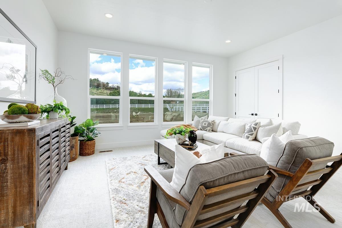 Carpeted living room featuring baseboards and recessed lighting
