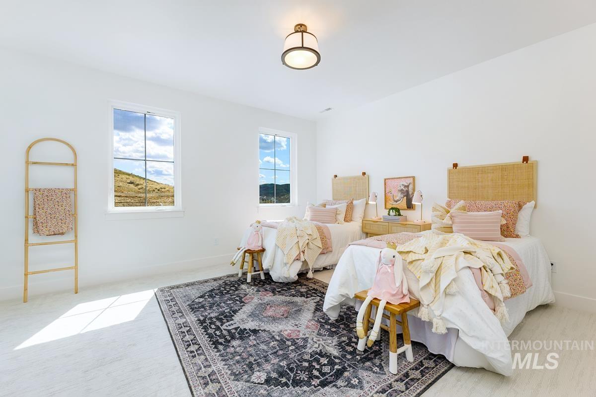 Bedroom with light carpet and baseboards