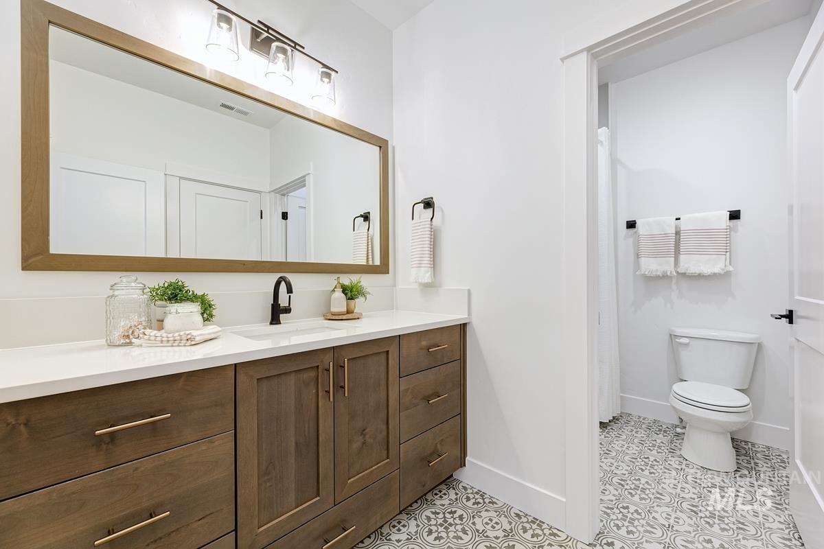 Bathroom featuring vanity, curtained shower, and light tile patterned floors