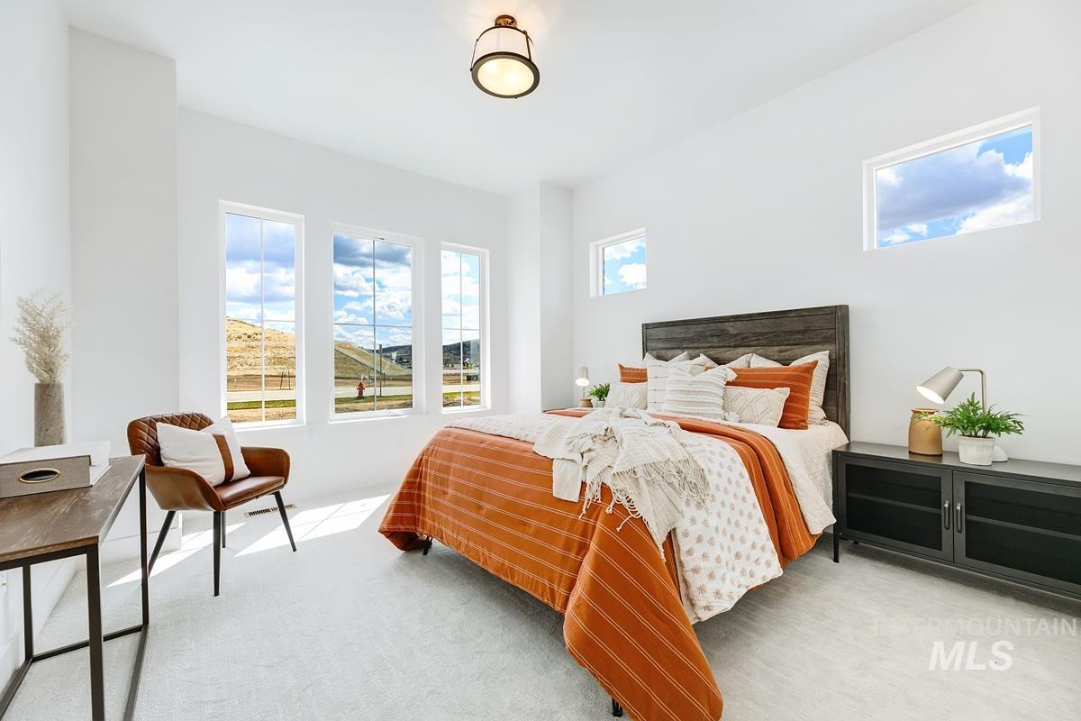 Bedroom with light colored carpet