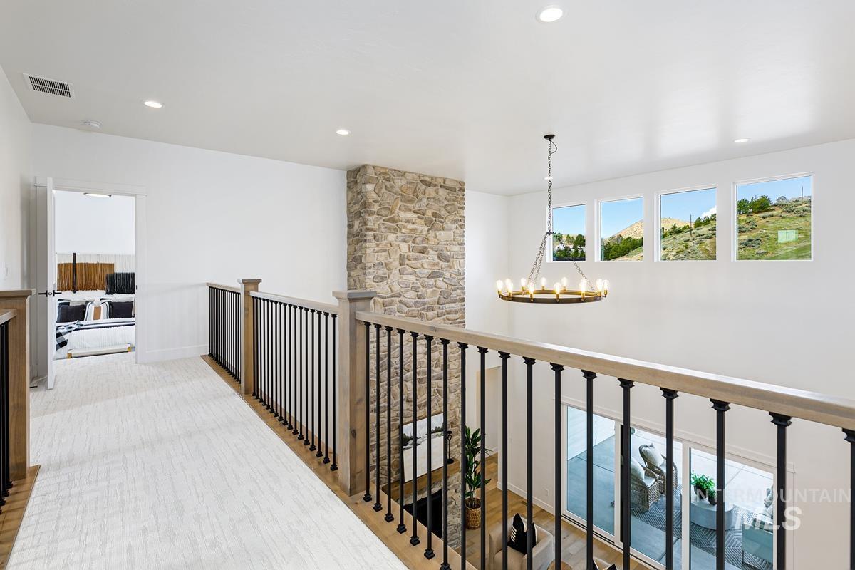 Hallway featuring a chandelier and recessed lighting
