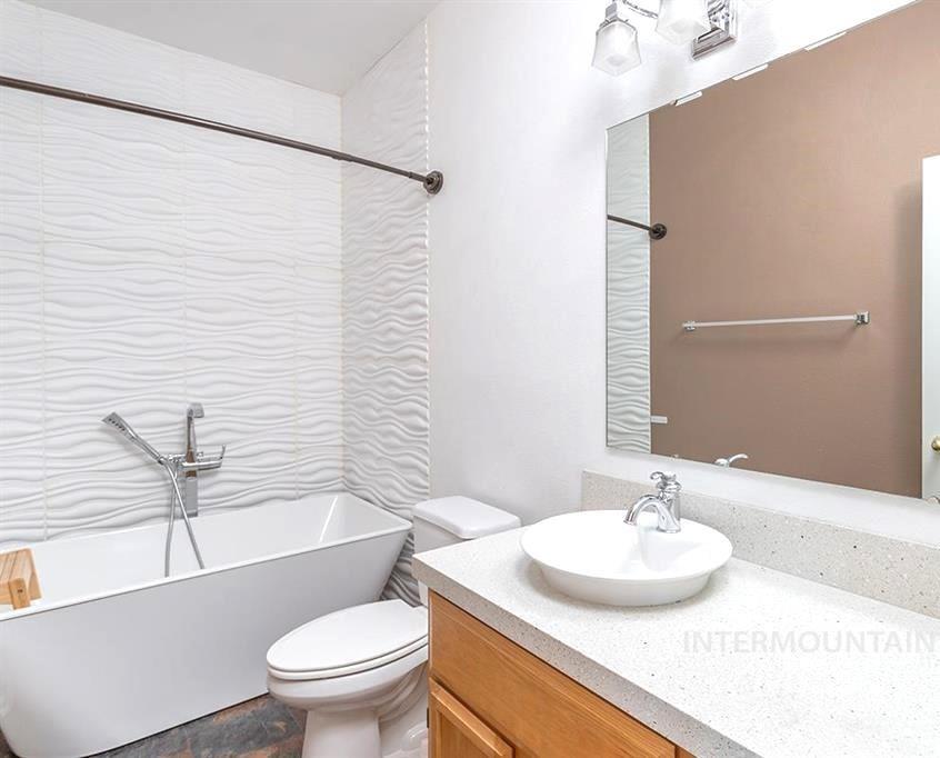 Full bath featuring a soaking tub and vanity
