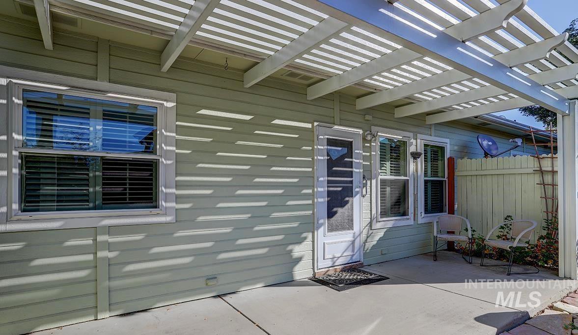 View of exterior entry featuring a patio and a pergola