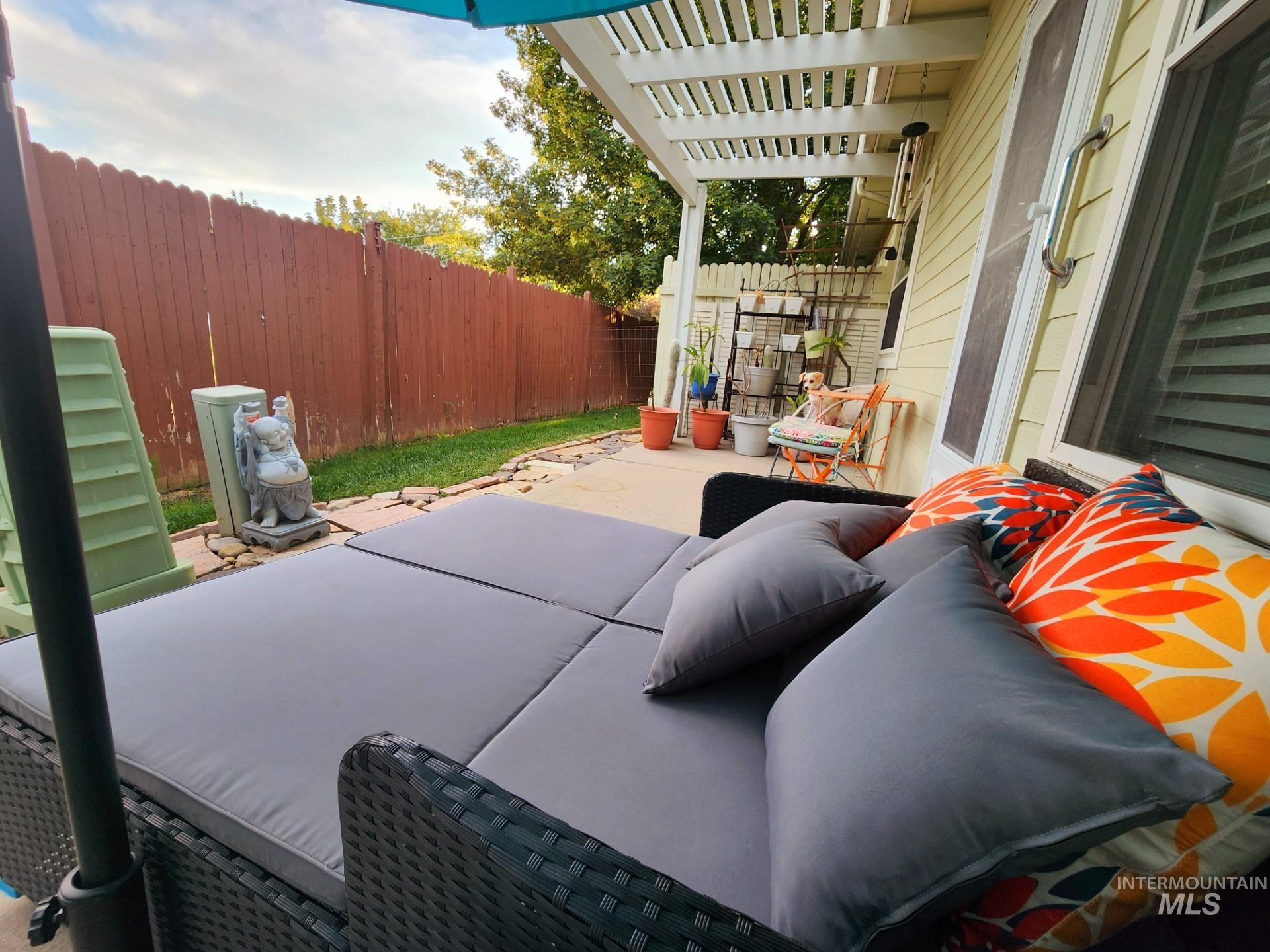 Fenced backyard with a patio and a pergola
