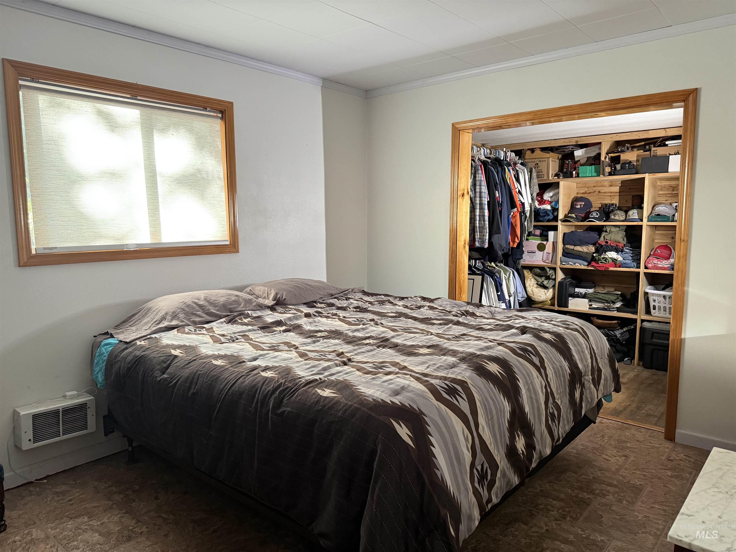 Bedroom featuring ornamental molding and a closet