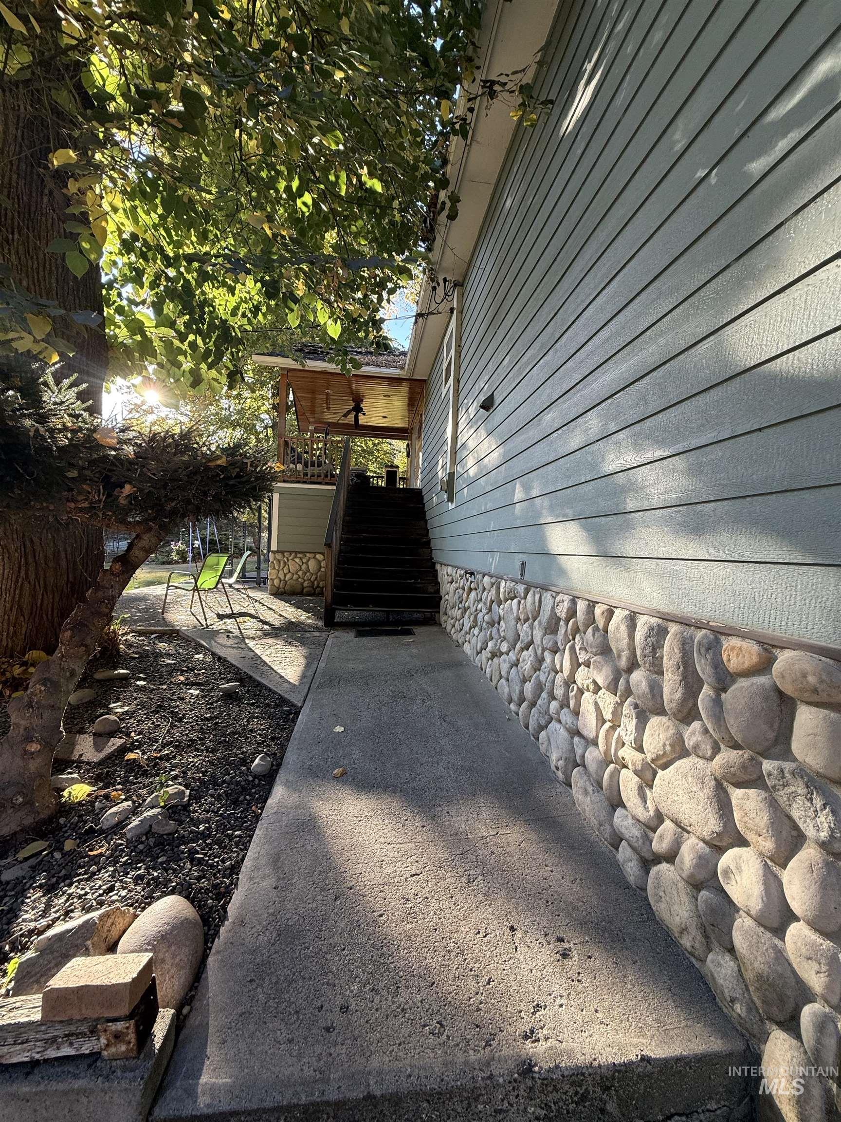 View of side of home featuring stairway