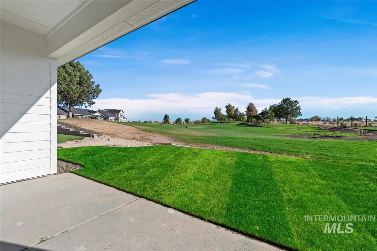 Expansive green lawn bordering a concrete patio