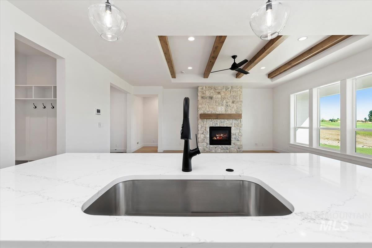 Quartz countertop with an undermount stainless steel sink and matte black faucet