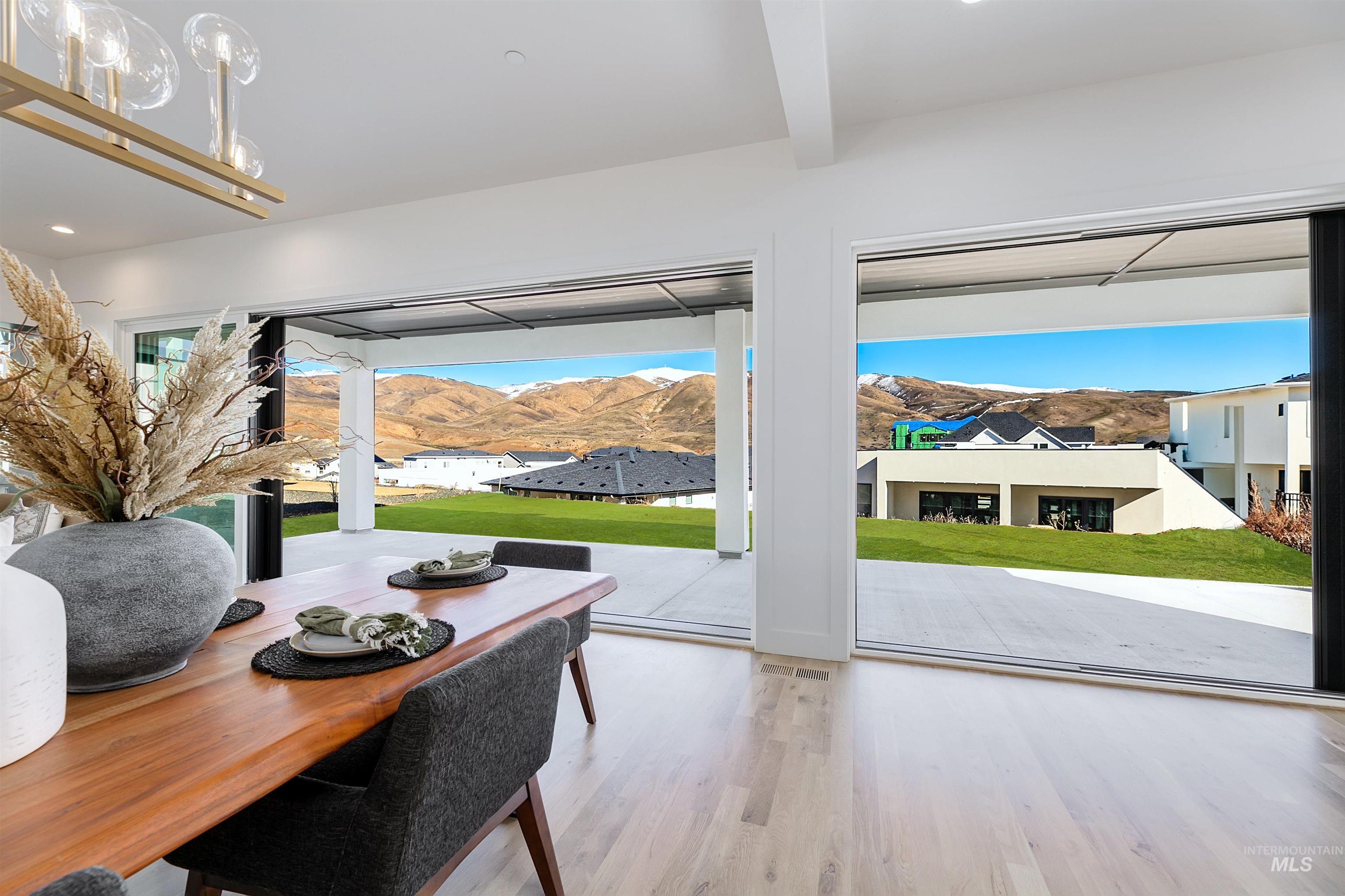 Dining room featuring a mountain view, wood finished floors, plenty of natural light, and recessed lighting