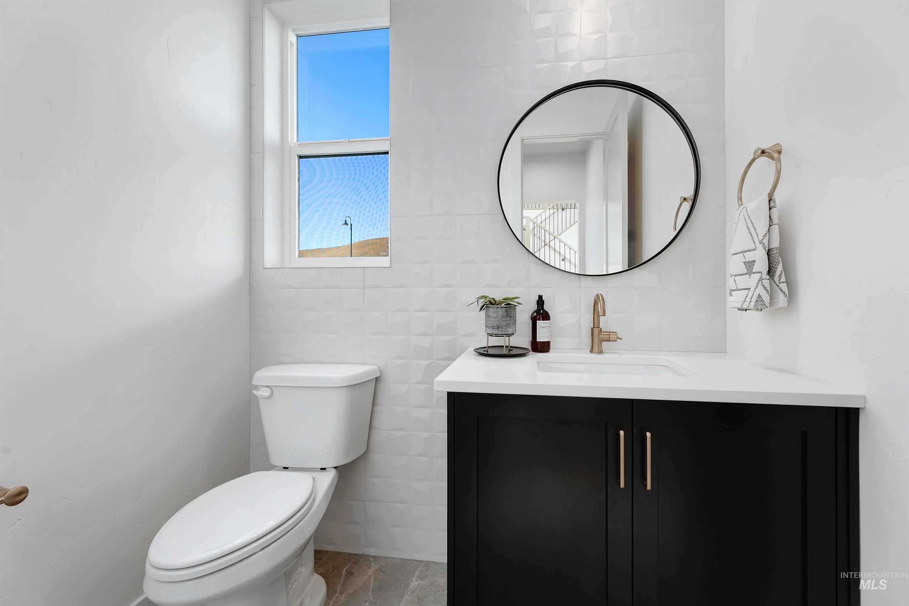 Bathroom featuring vanity and tile walls