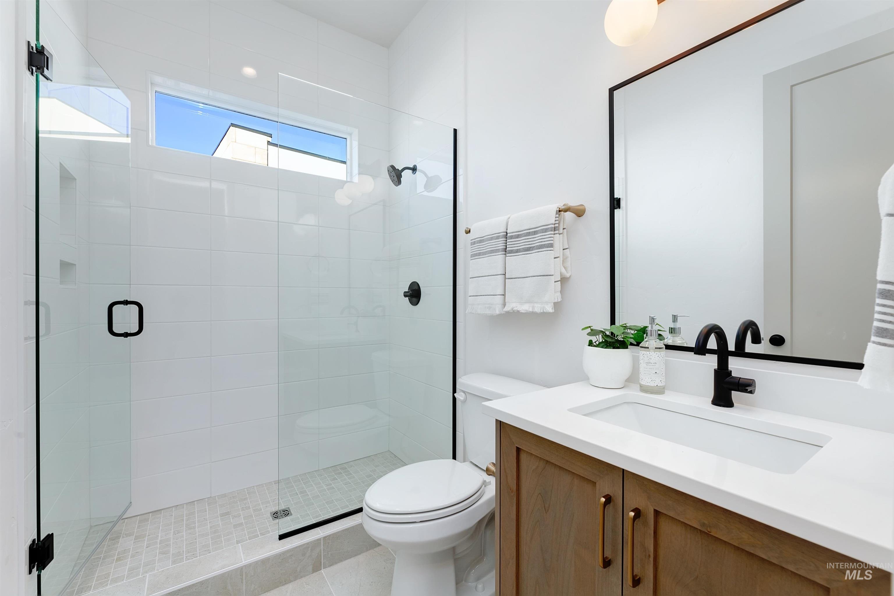 Full bath with vanity and a stall shower