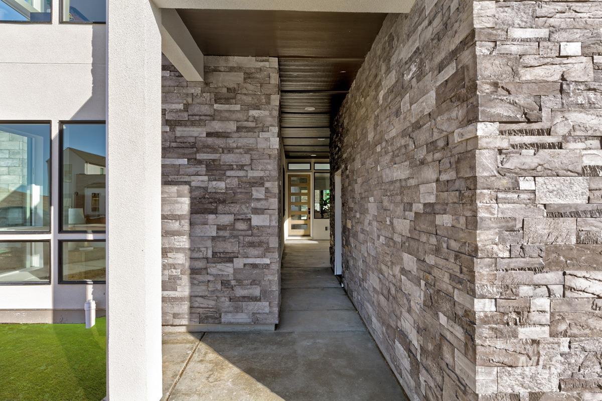 View of exterior entry featuring stone siding