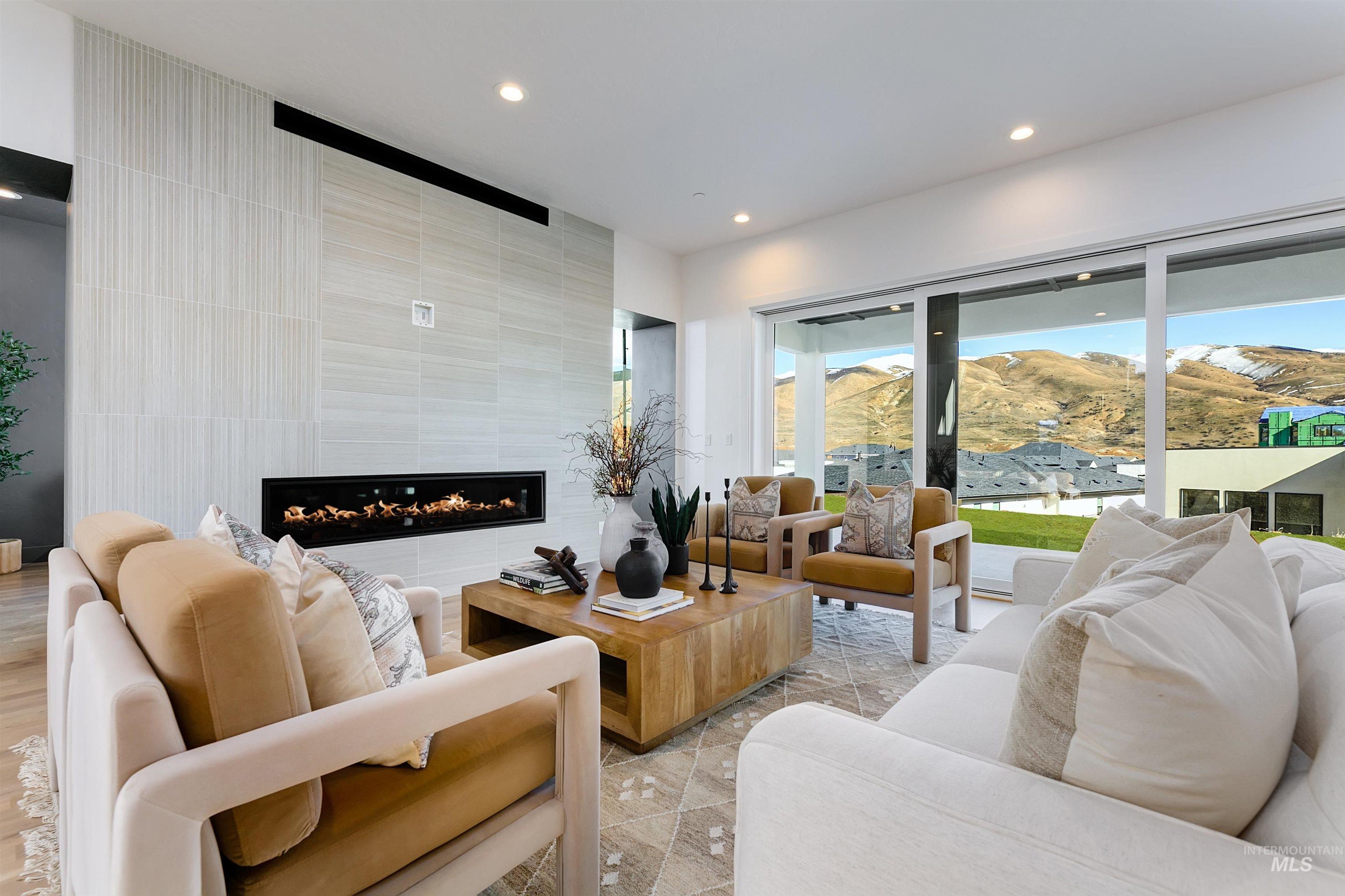 Living room featuring a tile fireplace, recessed lighting, and a mountain view