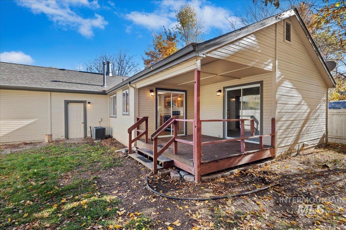 Rear view of property with roof with shingles and a deck